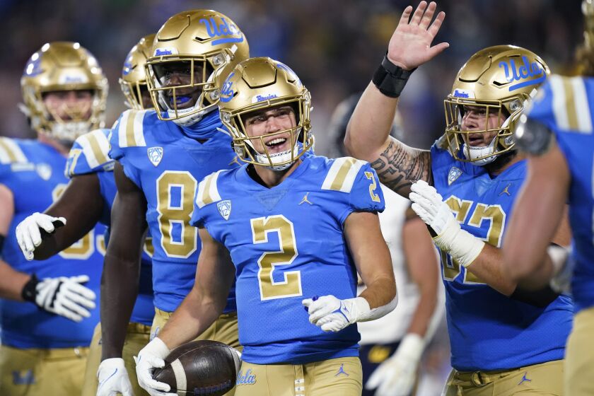 UCLA wide receiver Kyle Philips, center, celebrates his touchdown with teammates during the first half of an NCAA college football game against California on Saturday, Nov. 27, 2021, in Pasadena, Calif. (AP Photo/Jae C. Hong)