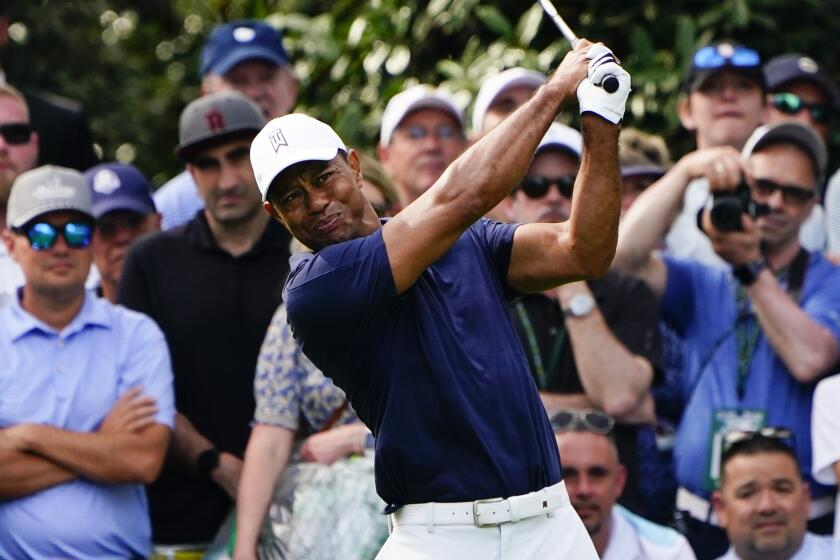 Tiger Woods tees off on the seventh hole during a practice round for the Masters golf tournament.