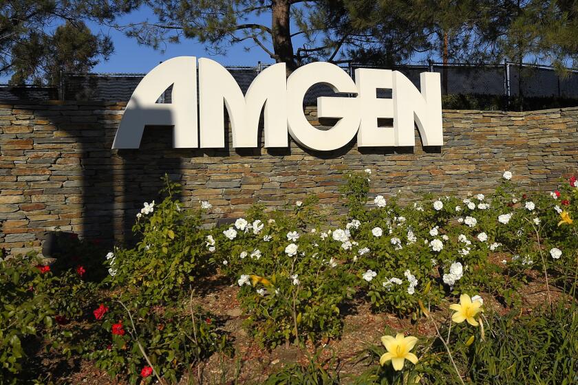 FILE - This photo shows signage outside the Amgen headquarters in Thousand Oaks, Calif on Nov. 9, 2014. Amgen will acquire Horizon Therapeutics, a biopharmaceutical company that focuses on treatments for rare, autoimmune diseases, in a deal valued at approximately $26.4 billion. (AP Photo/Mark J. Terrill, File)