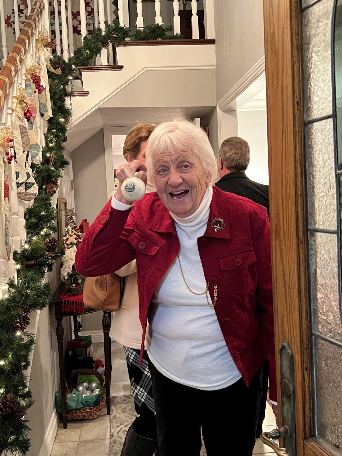 Longtime O'Meara Christmas party guest Kris Wesley displays her ornament at the 2021 party.