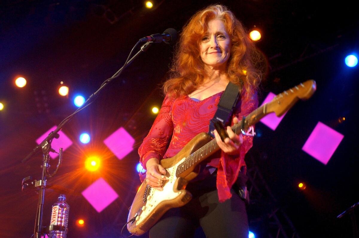 Bonnie Raitt, playing guitar