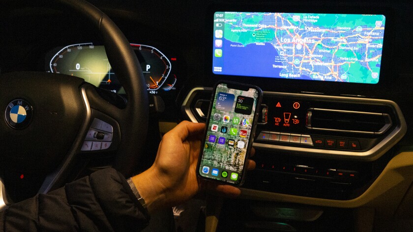 This photo provided by Edmunds is an example of wireless Apple CarPlay. This version removes the need for a messy USB cord and allows drivers to keep their phone in their pocket or neatly charging on a wireless charge pad. (Courtesy of Edmunds via AP)