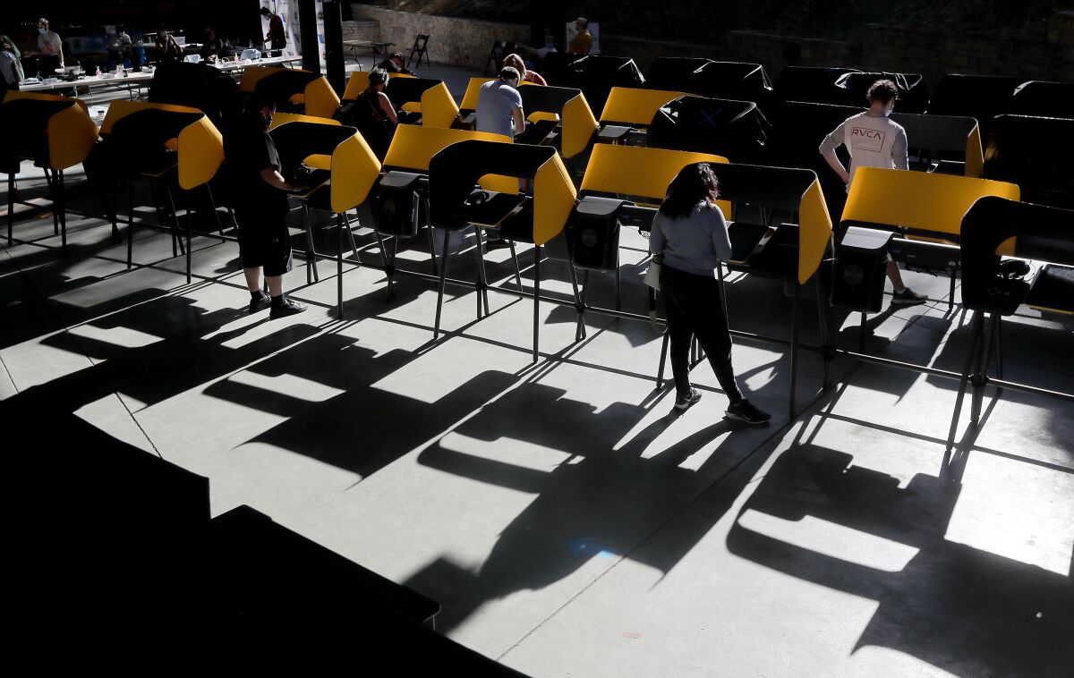 Voters fill out their ballots in voting booths at the Hollywood Bowl.