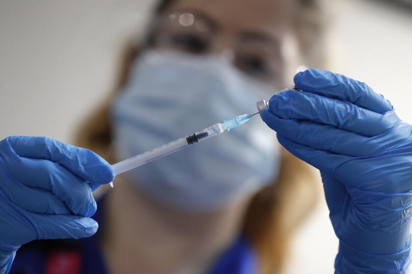 FILR - In this Tuesday, Dec. 8, 2020 file photo, a nurse prepares to administer the Pfizer-BioNTech COVID-19 vaccine at Guy's Hospital in London, U.K. Ugur Sahin, CEO of Biontech says the German pharmaceutical company is confident that the Pfizer-BioNTech COVID-19 vaccine works against the UK variant of the virus, but further studies are need to be completely sure. (AP Photo/Frank Augstein, Pool, file)