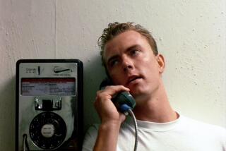 Barry Tubb, in white shirt at a payphone, as Lt. Leonard "Wolfman" Wolfe in "Top Gun"