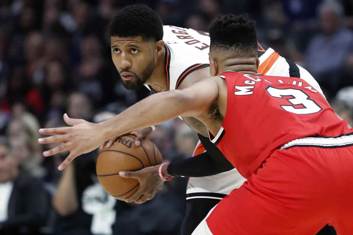 Clippers forward Paul George looks for an opening to the basket against Portland Trail Blazers guard CJ McCollum (3) in the first quarter at Staples Center on Tuesday.