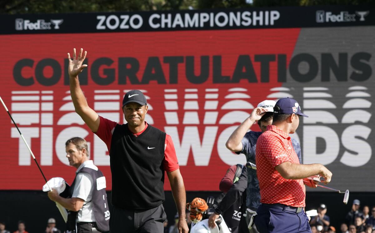 Tiger Woods celebrates after winning the Zozo Championship.