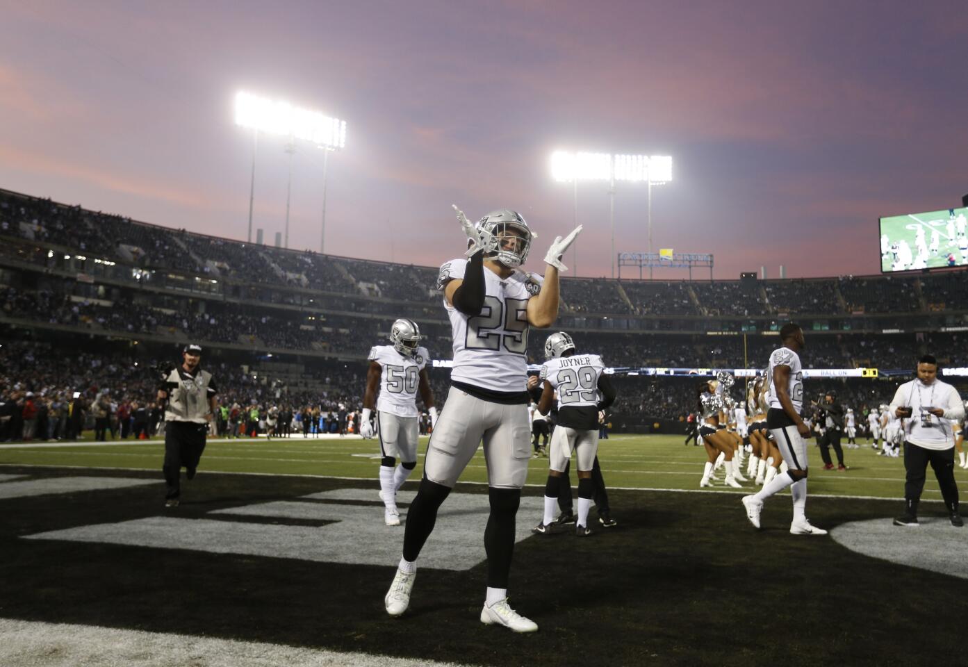 Raiders free safety Erik Harris (25) and his teammates warm up before a game against the Chargers on Nov. 7 at RingCentral Coliseum.