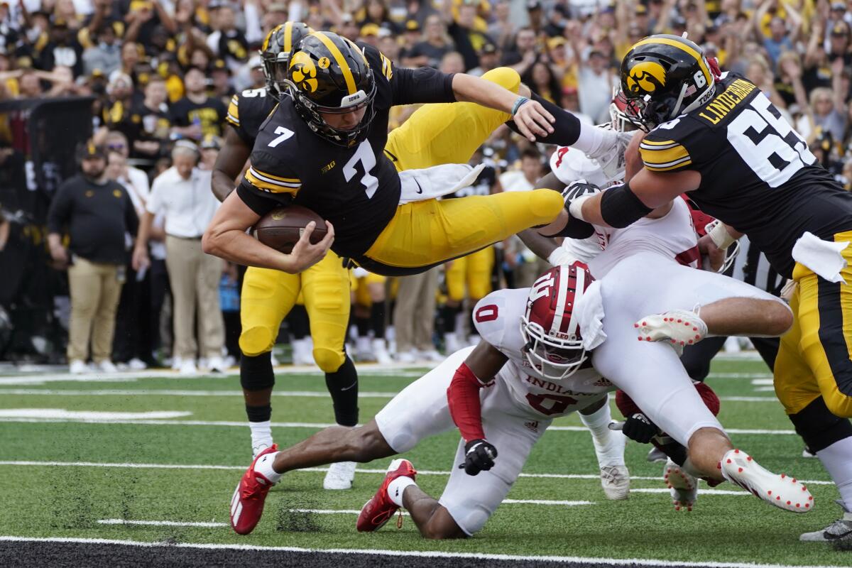 Iowa quarterback Spencer Petras (7) scores on a 9-yard touchdown run during the first half of an NCAA college football game against Indiana, Saturday, Sept. 4, 2021, in Iowa City, Iowa. (AP Photo/Charlie Neibergall)