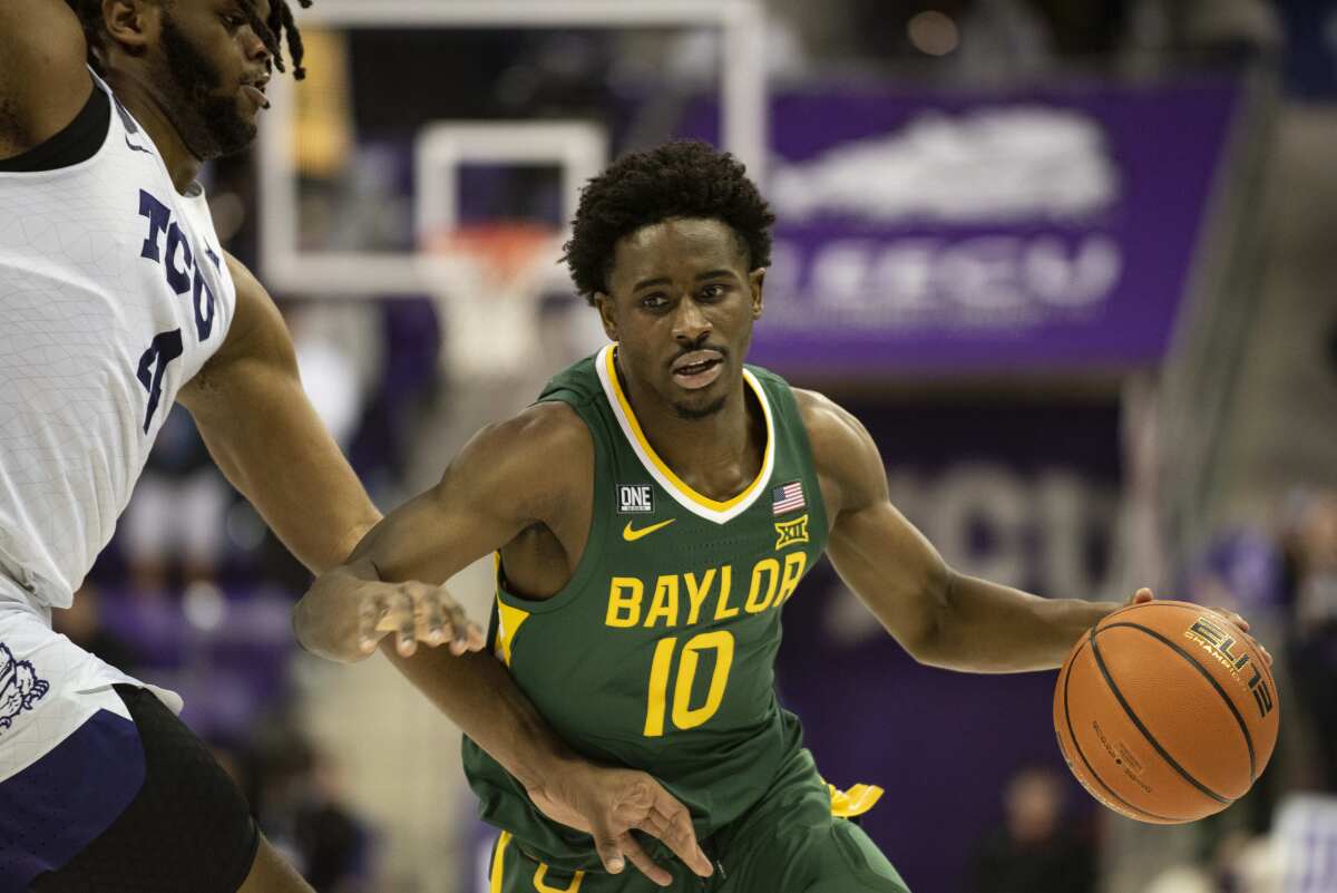 Baylor guard Adam Flagler (10) drives past TCU center Eddie Lampkin Jr. (4) to the basket in the first half of an NCAA college basketball game in Fort Worth, Texas, Saturday, Jan. 8, 2022. (AP Photo/Emil Lippe)