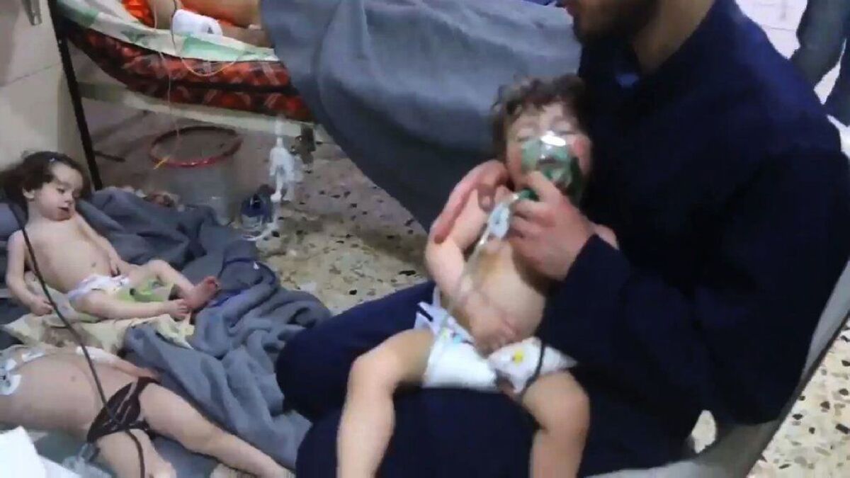 In an image taken from a video released by Syria Civil Defense, known as the White Helmets, a volunteer gives oxygen to a child at a hospital in Douma following a reported chemical attack on the rebel-held town on Sunday.