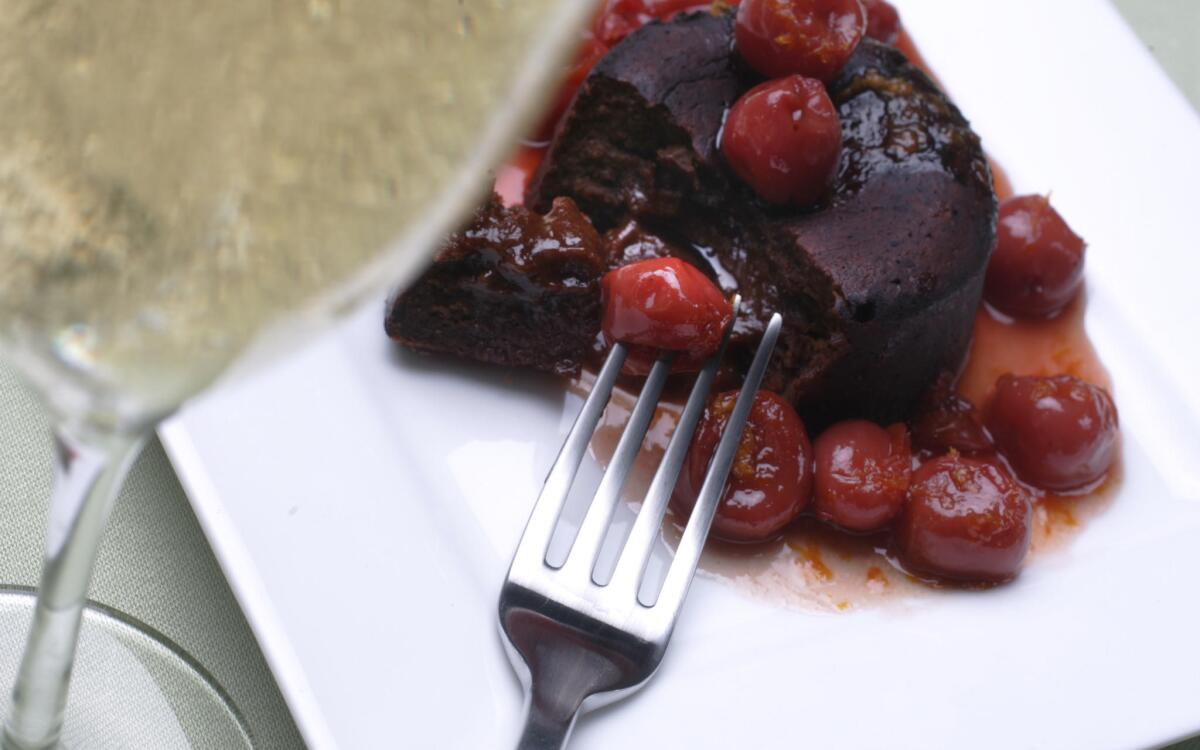 Flaming cherries over individual chocolate cakes