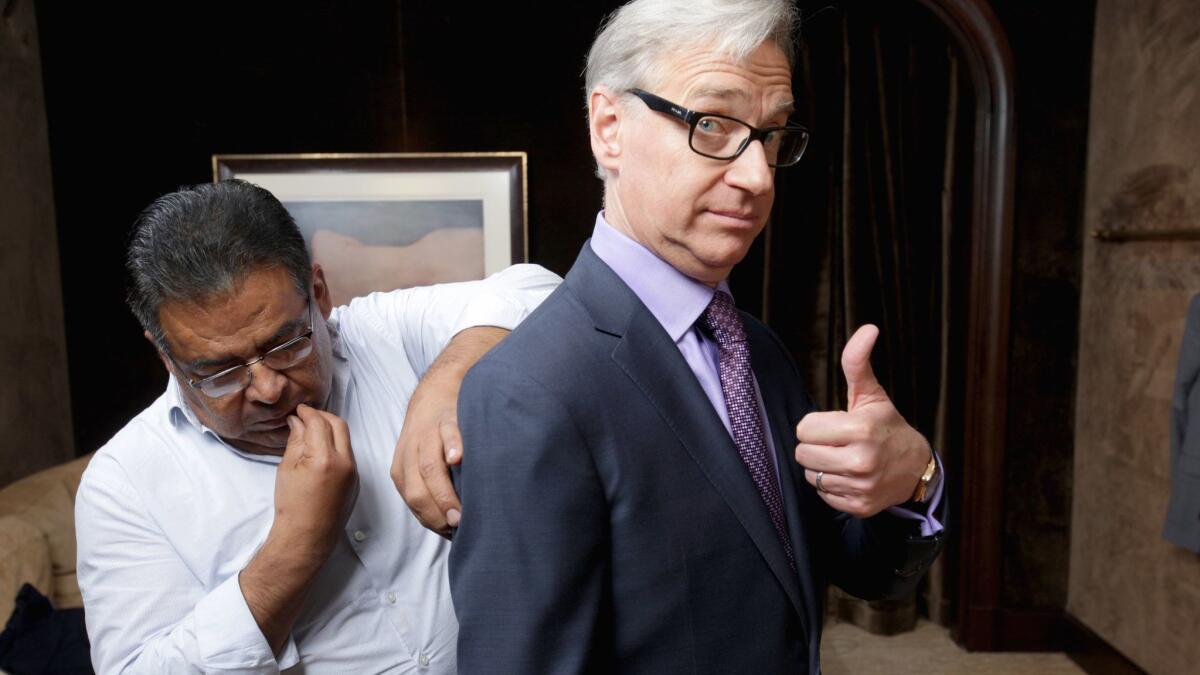 Tailor Mario Gonzales, left, marks director Paul Feig's Purple Label suit for alterations at the Ralph Lauren boutique in Beverly Hills recently. A self-described "wrinkle chaser," Feig says multiple fittings are key to getting a well-fitted suit.