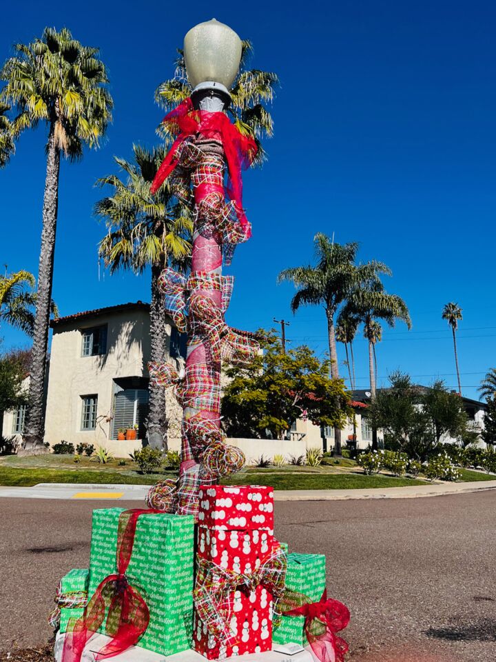 Street lamps in a Loma Portal neighborhood were decorated by residents in what has become an annual holiday decorating tradition.