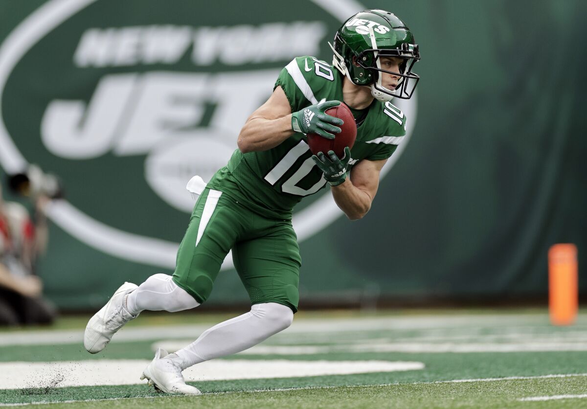 FILE - New York Jets wide receiver Braxton Berrios (10) runs with the ball during an NFL football game against the Tampa Bay Buccaneers, Sunday, Jan. 2, 2022, in East Rutherford, N.J. The New York Jets have re-signed All-Pro kick returner Braxton Berrios to a two-year, $12 million deal, keeping the versatile wide receiver after a breakout season. The deal Monday, March 14, 2022, includes $7 million fully guaranteed, according to Berrios' agent Drew Rosenhaus. (AP Photo/Adam Hunger, File)