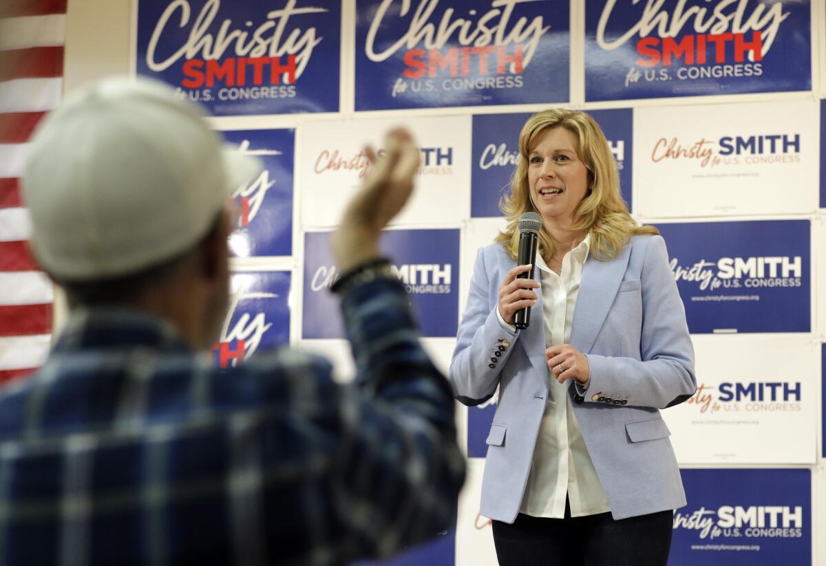 A woman holds a microphone.