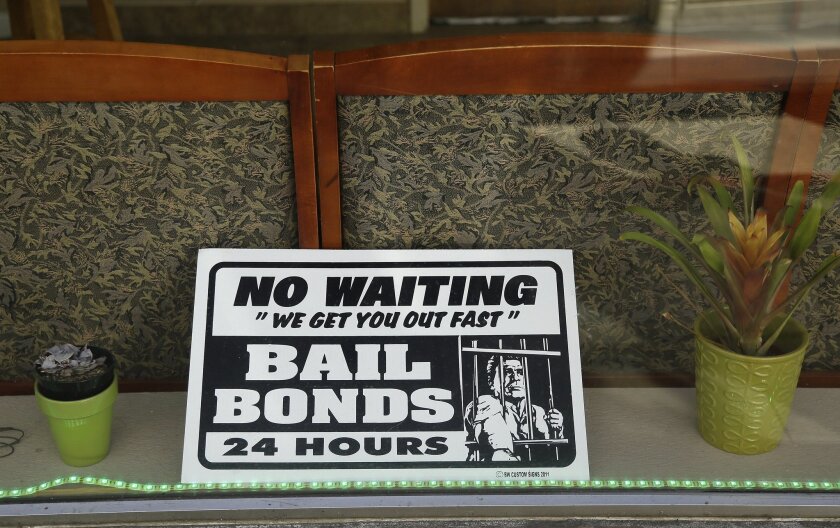 A sign is seen in the window of a bail bonds office across from the Hall of Justice in San Francisco on Dec. 23, 2015.
