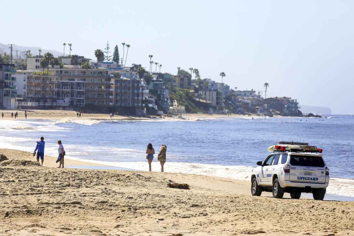 Lifeguards patrol the shore in Laguna Beach