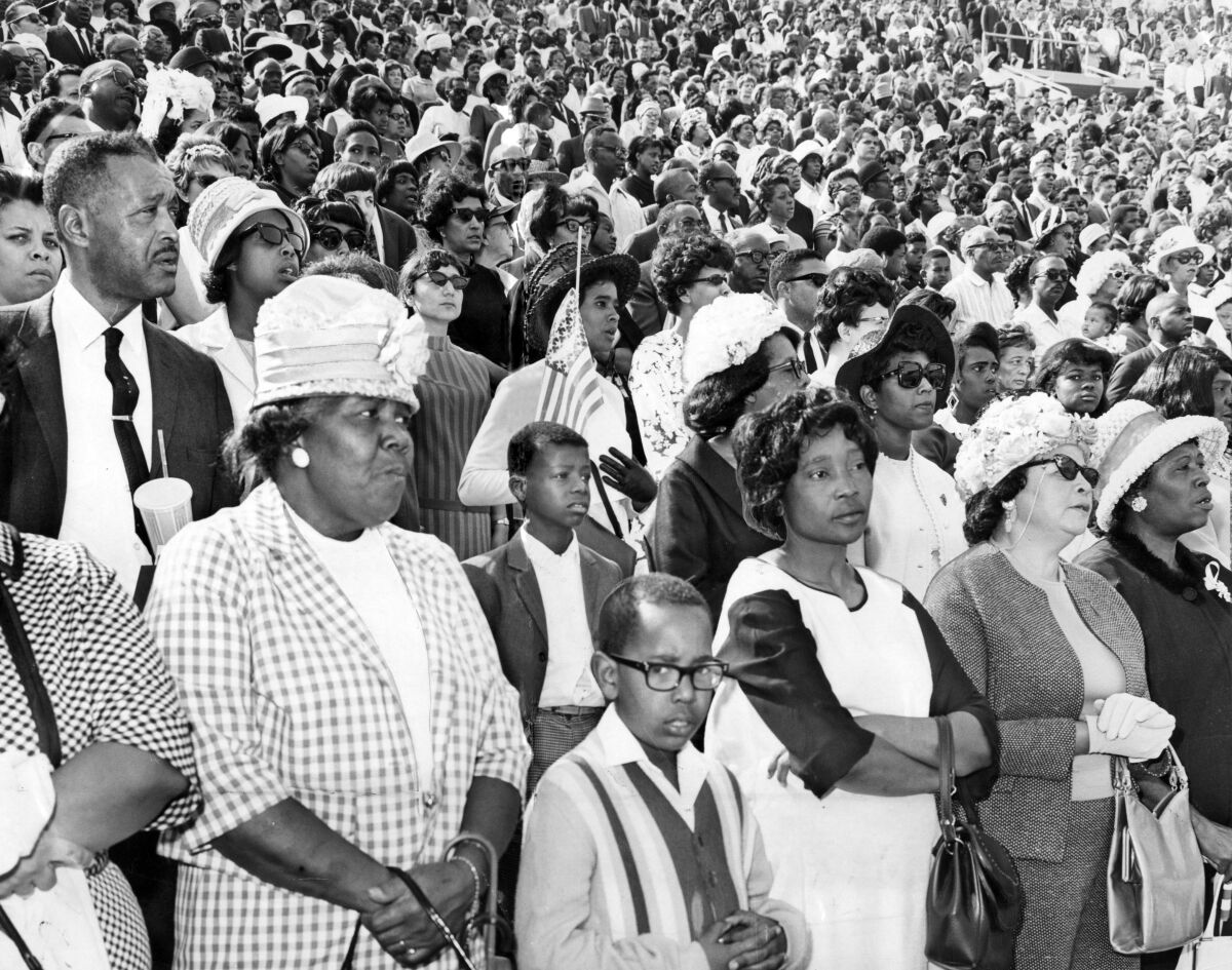 A crowd stands during a memorial service at the Coliseum for Dr. Martin Luther King Jr. at the Coliseum.