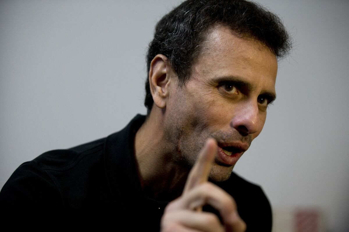 FILE - In this July 30, 2018 file photo, Venezuela's opposition leader Henrique Capriles speaks during an interview at his office in Caracas, Venezuela. Capriles broke on Wednesday, Sept. 2, 2020, with U.S.-backed leader Juan Guaido, whose coalition has vowed to boycott the crisis-torn nation's upcoming congressional elections claiming they're rigged. (AP Photo/Fernando Llano, File)