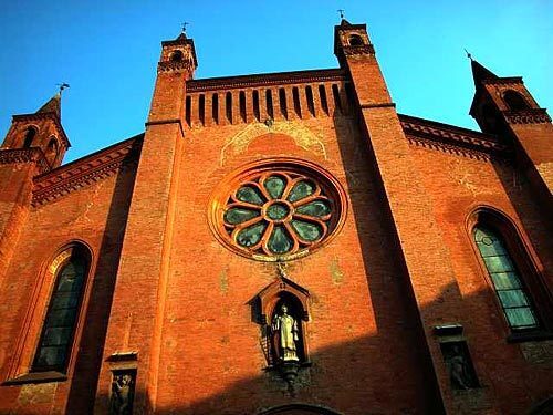 The red brick of a cathedral warms the medieval town of Alba in the Piedmont region of Italy, near Turin.