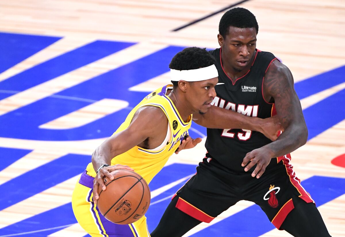 Lakers guard Rajon Rondo drives past Miami Heat guard Kendrick Nunn.