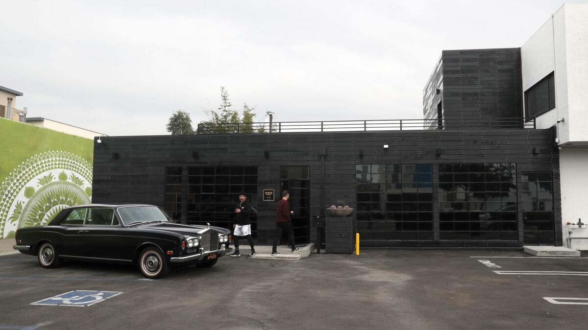 A look at the exterior of the new Hoorsenbuhs store in Santa Monica. Outiside, brand founder and designer Robert Keith walks to his restored, matte black 1973 Rolls-Royce Corniche.