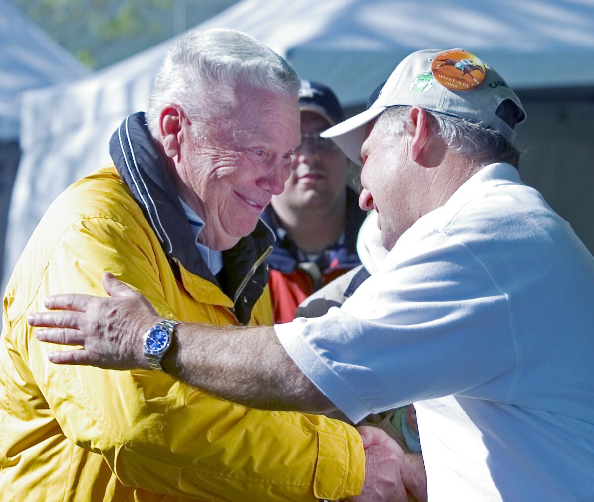 Two men shaking hands and embracing