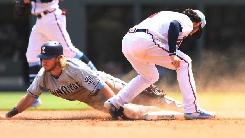 Travis Jankowski is tagged out by Dansby Swanson after sliding past second base on a sixth-inning steal attempt Sunday at SunTrust Park.