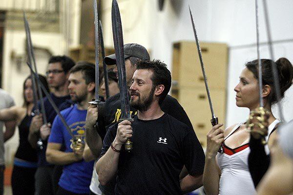 Brian Danner, owner of Sword Fights Inc., is shown at the conclusion of sword fighting practice in April. He trains actors for sword-fighting scenes in movies, TV and stage.