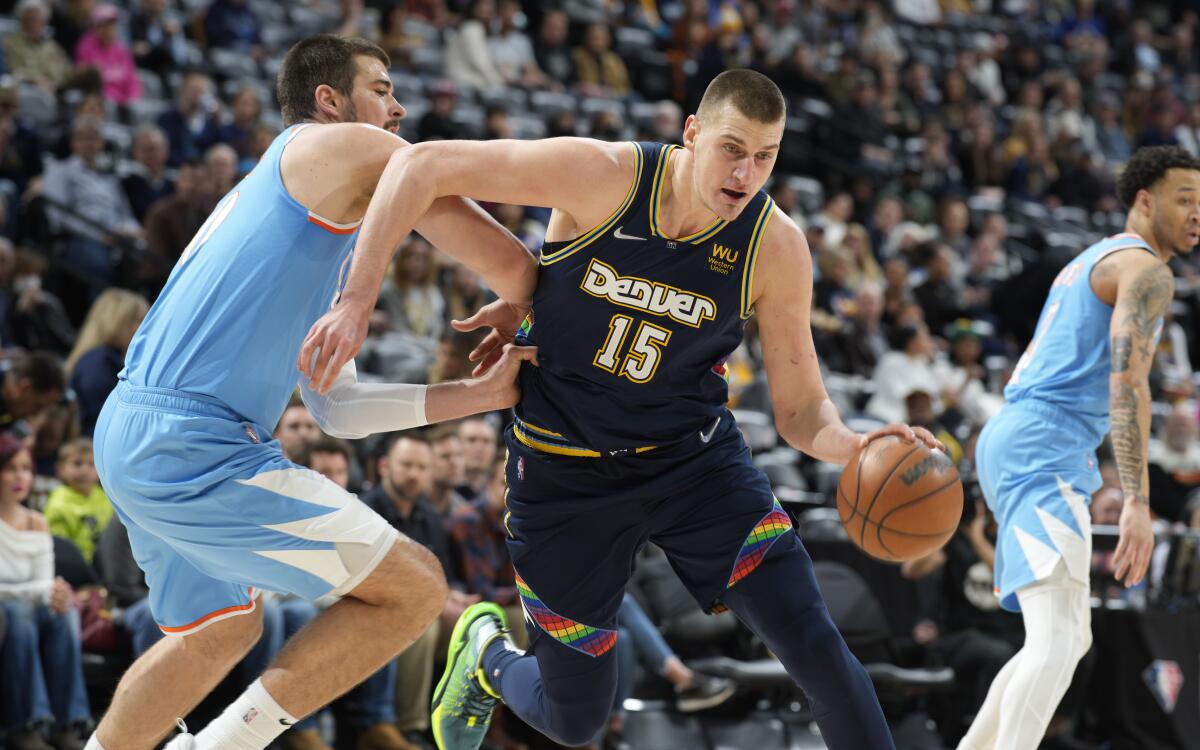 Denver Nuggets center Nikola Jokic drives to the rim past Clippers center Ivica Zubac.