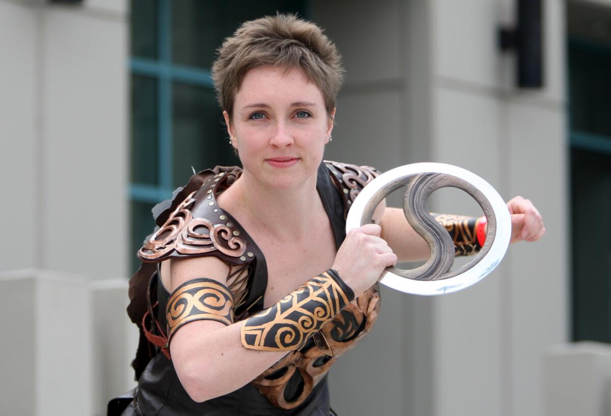 Cosplayer Lauren Saalmuller, 24 of Boston, srrikes a pose as Xena the princess warrior, at the Xena Warrior Princess 20th Anniversary Celebration, The Absolute Last Official Xena Convention: The Bittersuite Finale at the Burbank Marriott Convention Center in Burbank on Friday, Feb. 20, 2015. The convention continues through the weekend.
