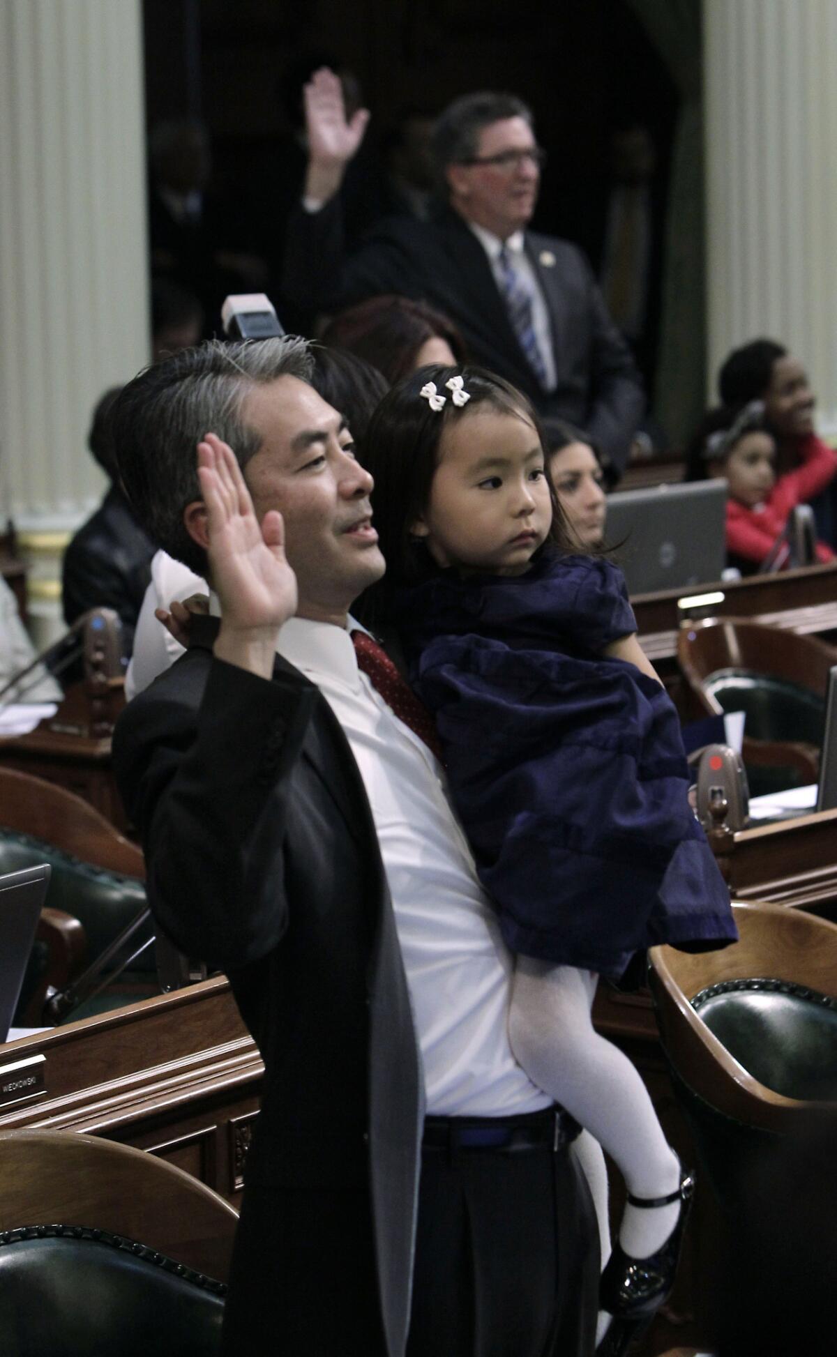 Assemblyman Al Muratsuchi holds his daughter, Sophia, as he is sworn in to office in 2012. He said Thursday he will run for reelection.
