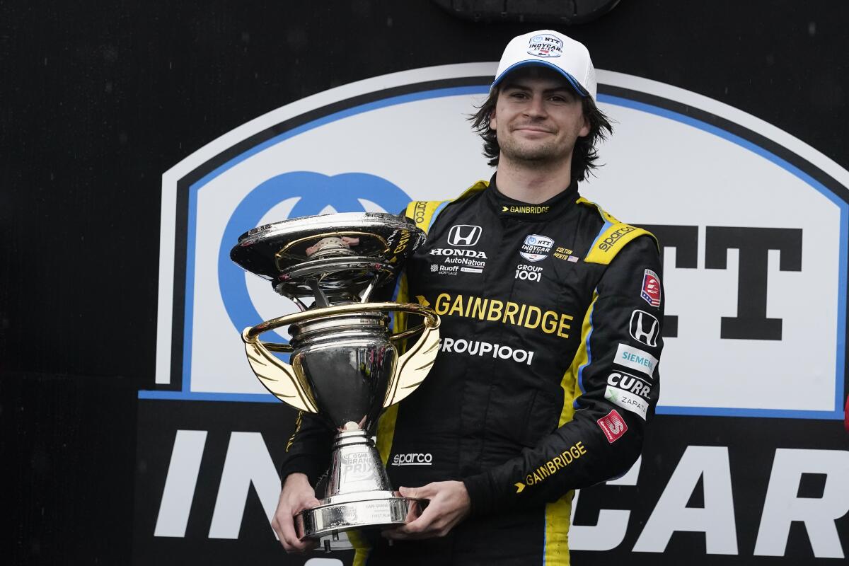 Colton Herta celebrates on the podium after winning the IndyCar Grand Prix at Indianapolis Motor Speedway on May 14.