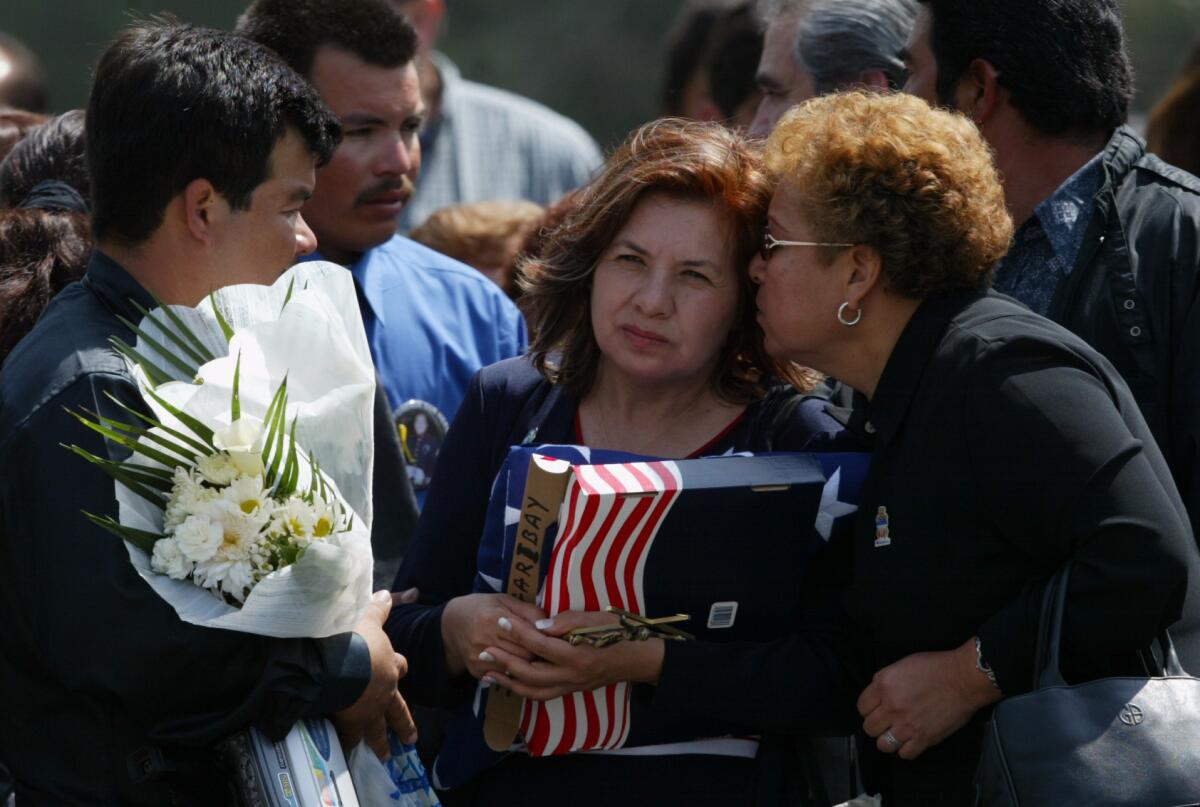 Simona Garibay is comforted by family and friends at the funeral of her son, Jose Garibay, who was killed in Iraq. (Gina Ferazzi / Los Angeles Times)