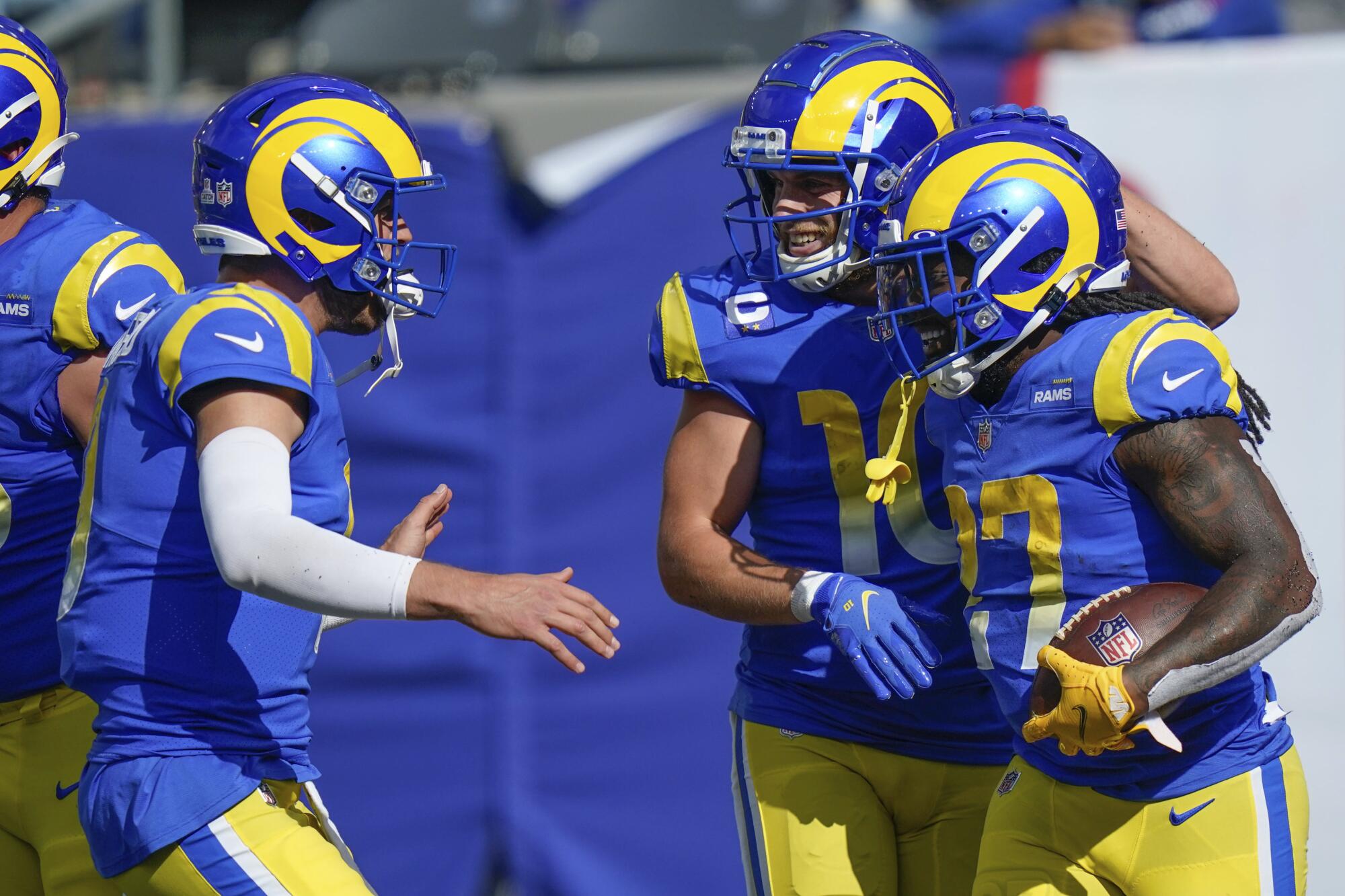 Rams' Darrell Henderson celebrates his touchdown with quarterback Matthew Stafford and Cooper Kupp.