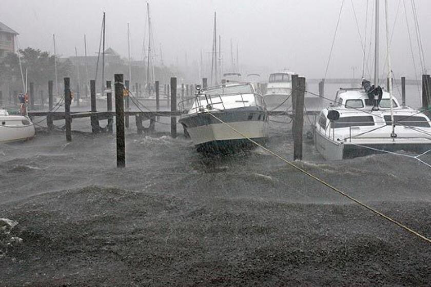 Boats docked along the waterfront rock in the wind and rain from Tropical Storm Hanna in Manteo, N.C., Saturday.