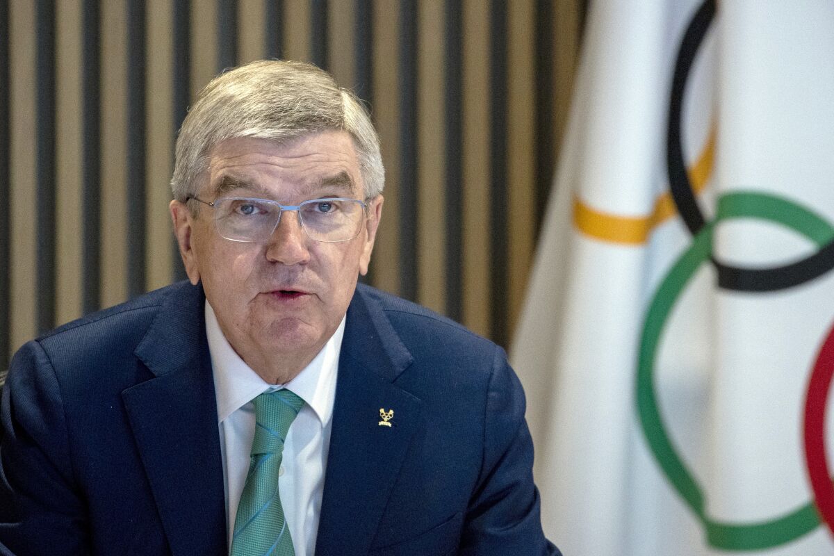 FILE - International Olympic Committee, IOC, President Thomas Bach attends the opening of the Executive Board meeting at the Olympic House in Lausanne, Switzerland, on Dec. 5, 2022. Bach defended his organization's efforts to create a pathway for Russian and Belarusian athletes to return to Olympic competition in a speech in his home country of Germany which took place amid a pro-Ukraine protest, Wednesday, March 22, 2023, (Denis Balibouse/Pool Photo via AP, File)