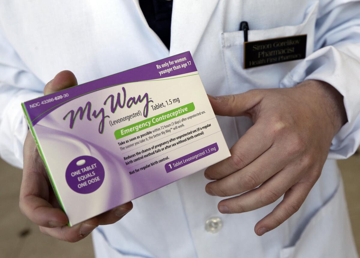 FILE - Pharmacist Simon Gorelikov holds a generic emergency contraceptive at the Health First Pharmacy in Boston on May 2, 2013. Some leaders in states that ban abortions at all points of pregnancy say exceptions for rape or incest victims aren't needed because emergency contraceptives can be used instead. But medical professionals and advocates for rape survivors say that while emergency contraception is a helpful tool, it's not always foolproof, and getting access to these emergency measures in the short timeframe in which they would be effective may not be realistic for someone who has just been assaulted. (AP Photo/Elise Amendola, File)