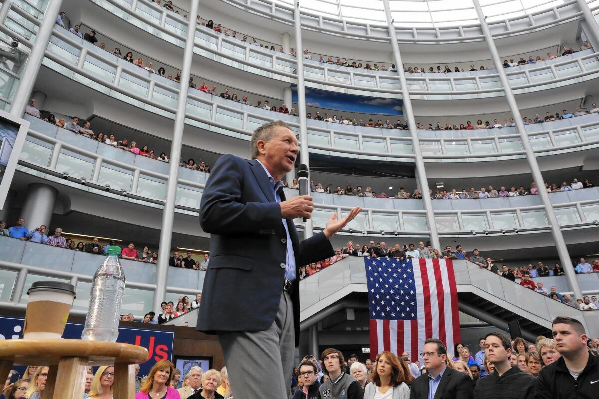 Ohio Gov. John Kasich campaigns Wednesday in Lisle, Ill. His presidential hopes are staked on him winning his home state next week.
