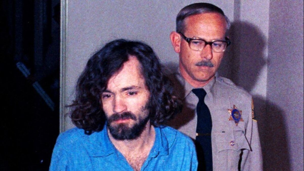 Charles Manson is escorted by deputies to court in Los Angeles on Aug. 20, 1970.