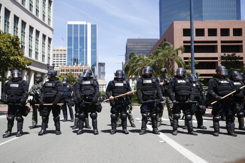 San Diego police in riot gear lined Broadway in downtown San Diego stopping a group of protesters on May 31, 2020. The group was protesting the death of George Floyd.