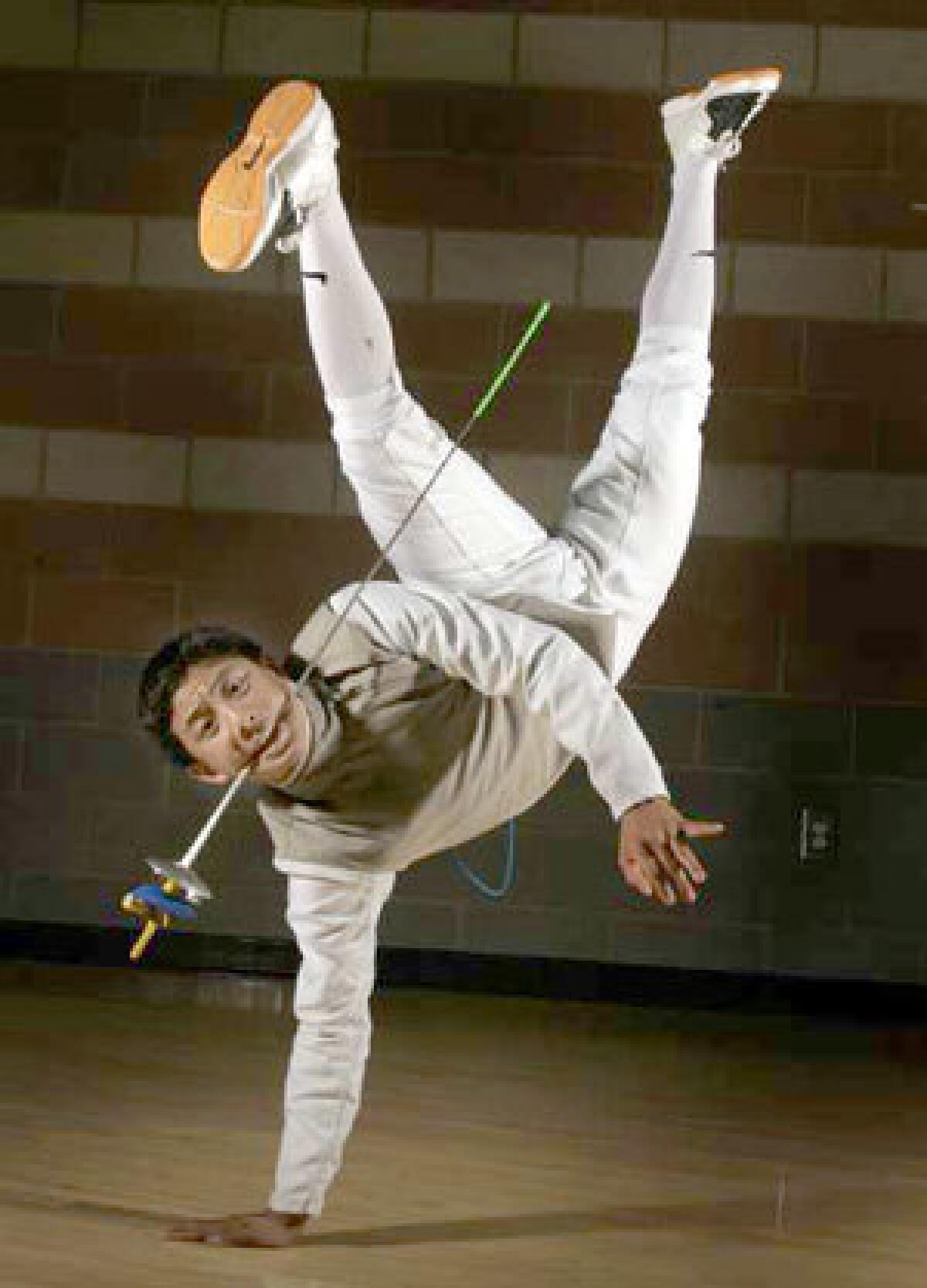 Brennan Louie, a junior at the L.A. Center for Enriched Studies, uses break dancing as part of his fencing training. He hopes to compete in the Olympics.