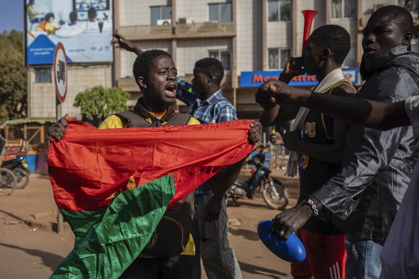 Protestors take to the streets of Burkina Faso's capital Ouagadougou Saturday Jan. 22, 2022, 27, 2021, protesting the government's inability to stop jihadist attacks spreading across the country and calling for President Roch Marc Christian Kabore to resign. (AP Photo/Sophie Garcia)