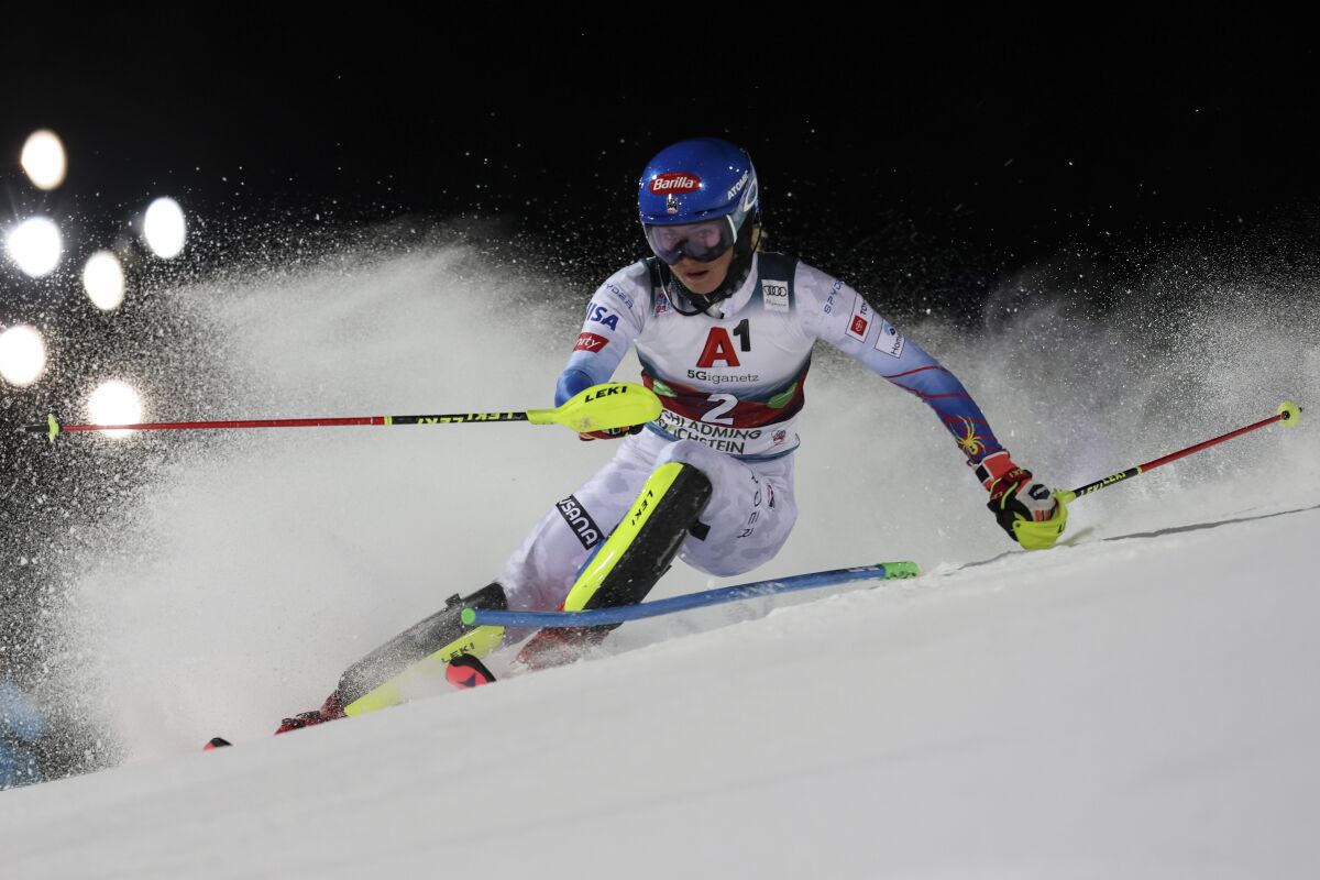 FILE - United States' Mikaela Shiffrin speeds down the course during the first run of an alpine ski women's World Cup slalom, in Schladming, Austria, Jan. 11, 2022. (AP Photo/Marco Trovati, File)