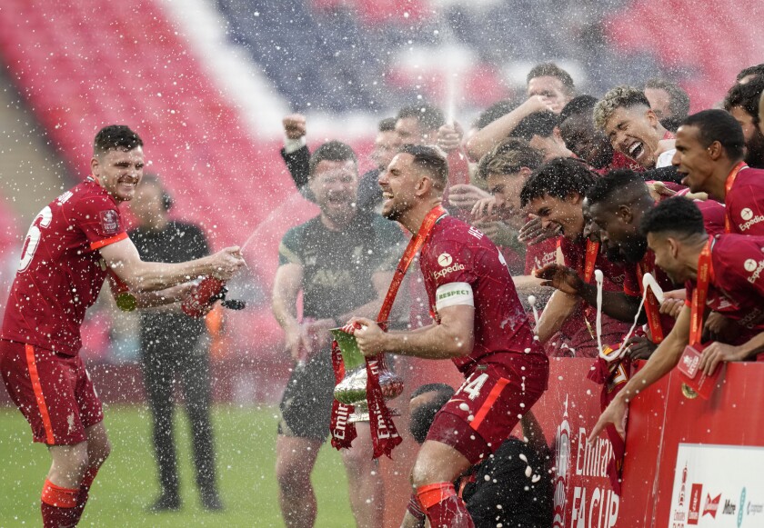 Liverpool players celebrate at the end of the English FA Cup final soccer match between Chelsea and Liverpool, at Wembley stadium, in London, Saturday, May 14, 2022. (AP Photo/Kirsty Wigglesworth)