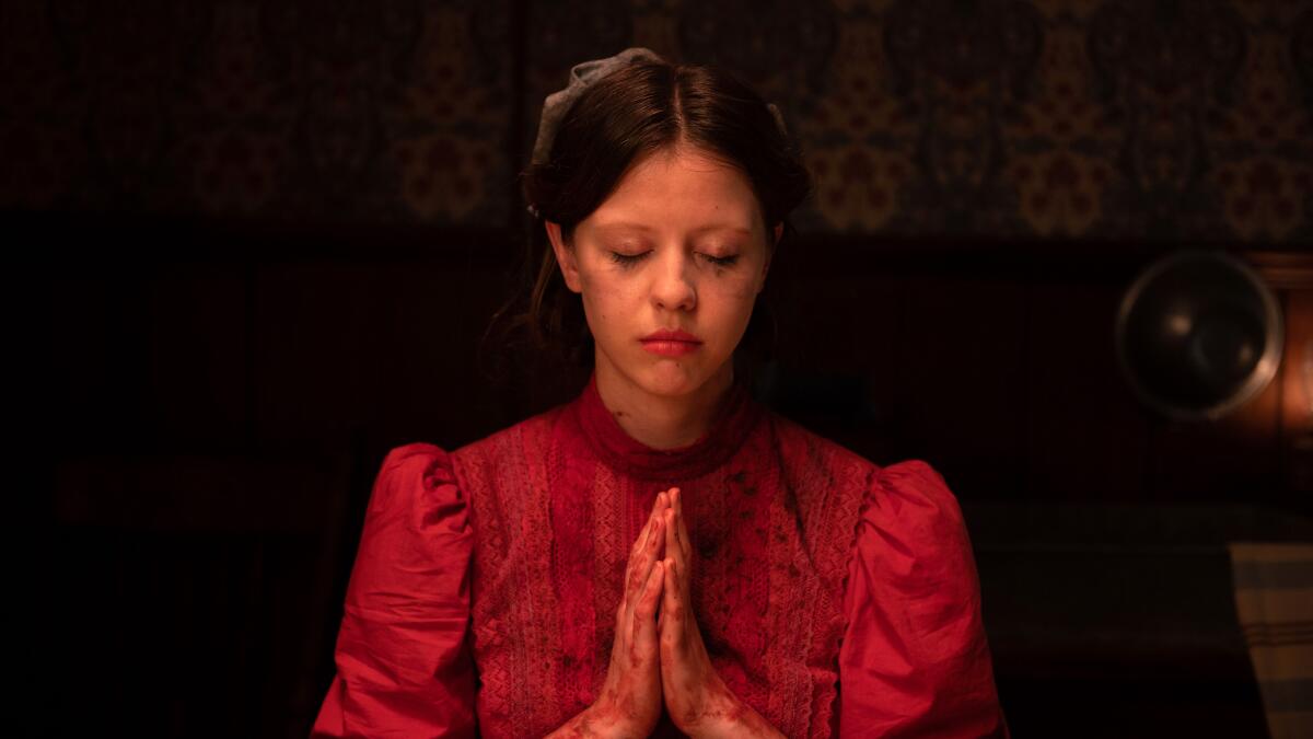 A woman holds her hands in prayer