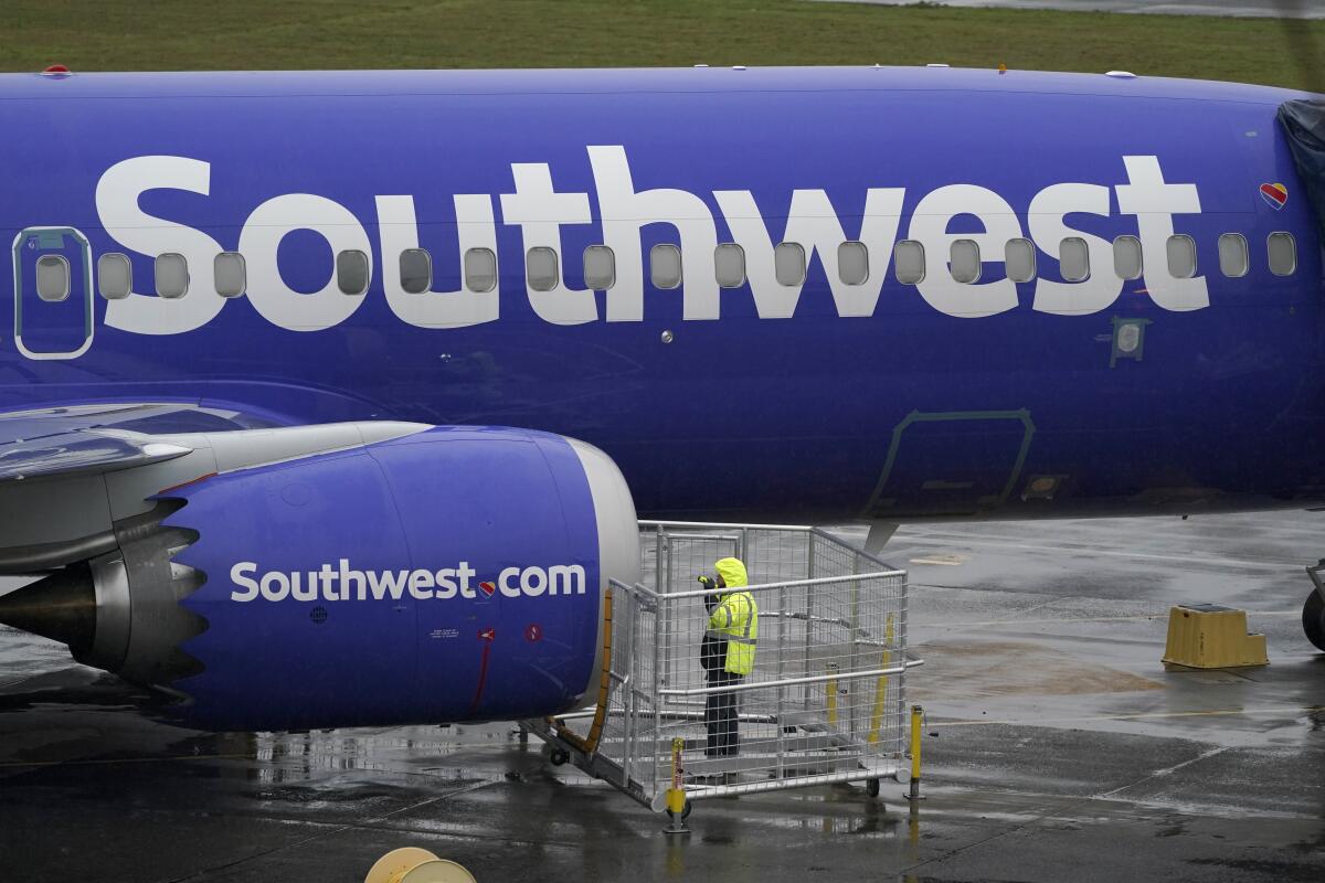 A worker inspects a Southwest airplane
