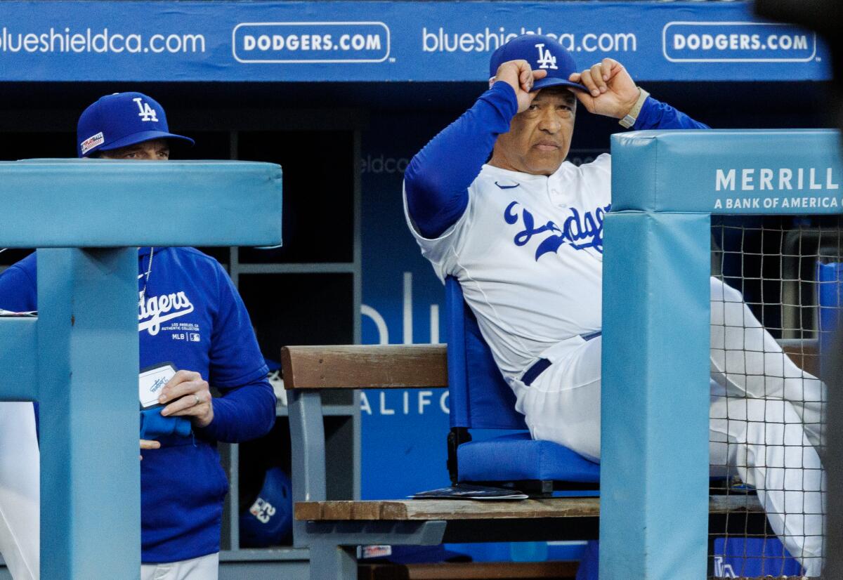 Dodgers manager Dave Roberts pulls down his cap after Blake Treinen walks a Kansas City Royals batter.