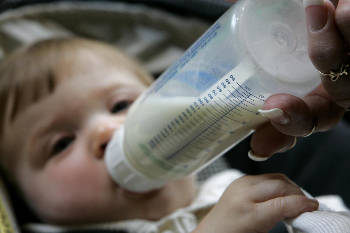 Holly Schafer feeds her daughter, Alexandria, in this 2007 file photo. The Social Security Administration released its annual list of top baby names on Friday.